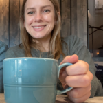 Ashley holding a cup of coffee